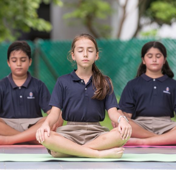 Students meditating on the school grounds