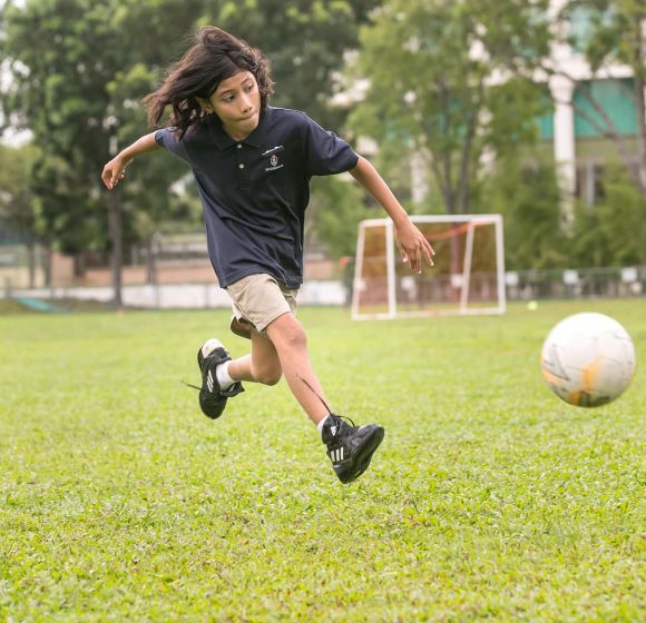 Student kicking a ball