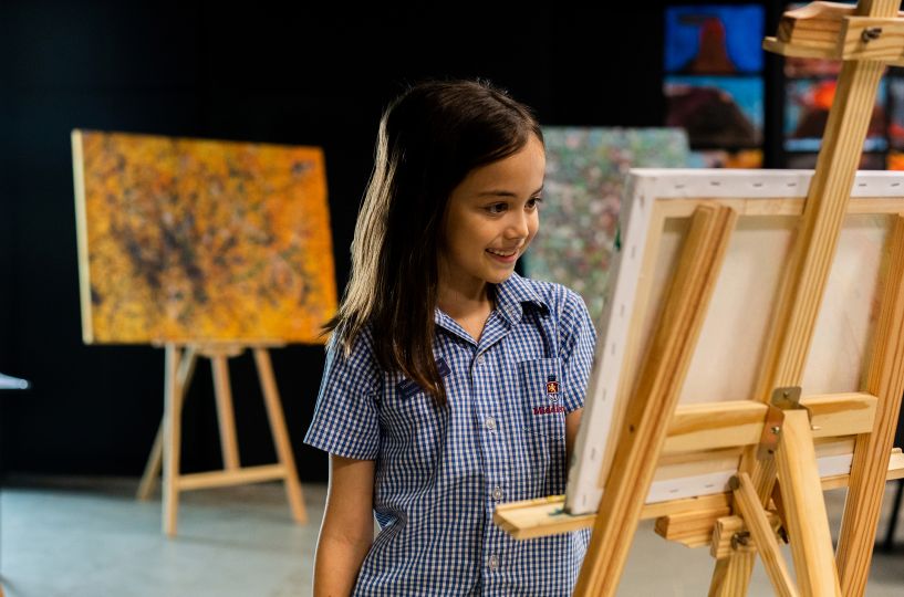 A student doing a painting in art class